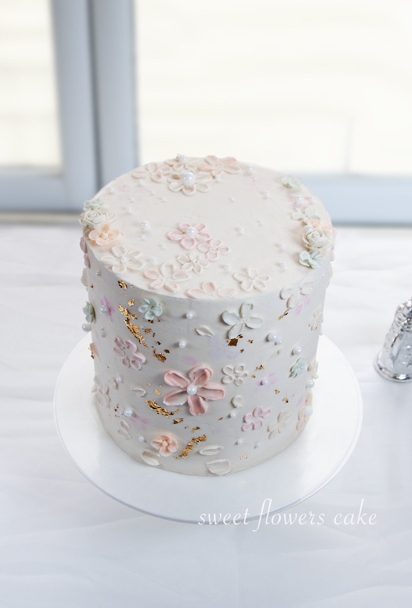 Elegant Vanilla Buttercream Cake with Gold Flakes